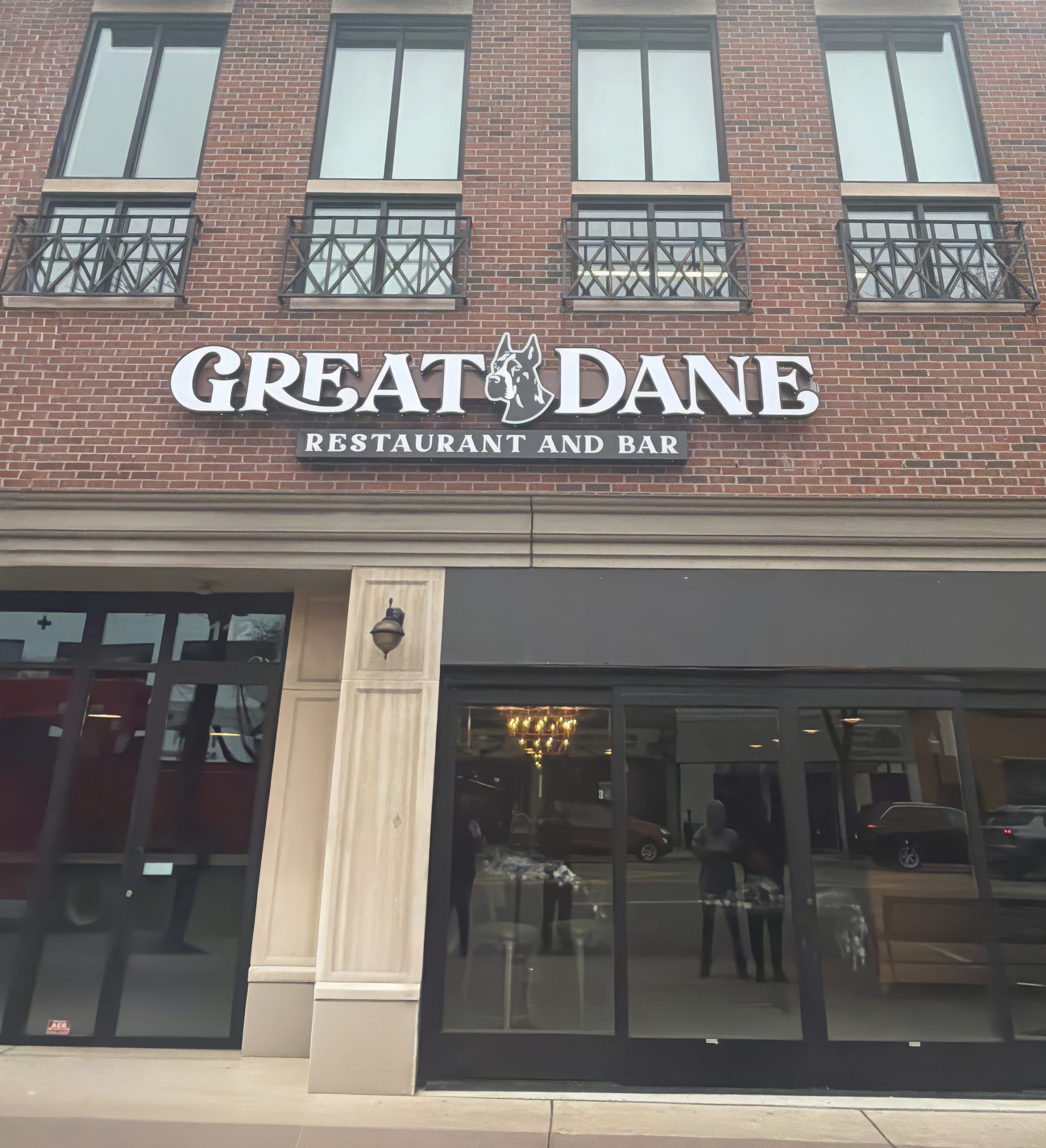 Great Dane Restaurant Channel Letter Sign Installation in in Royal Oak, MI Illuminated channel letter sign for The Great Dane Restaurant and Bar installed on brick storefront in Royal Oak, MI