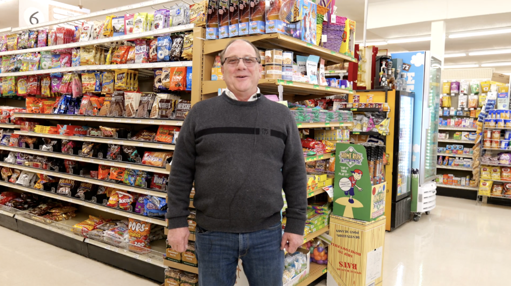 Jerry Monte, manager of Village Market, stands inside the store surrounded by product shelves